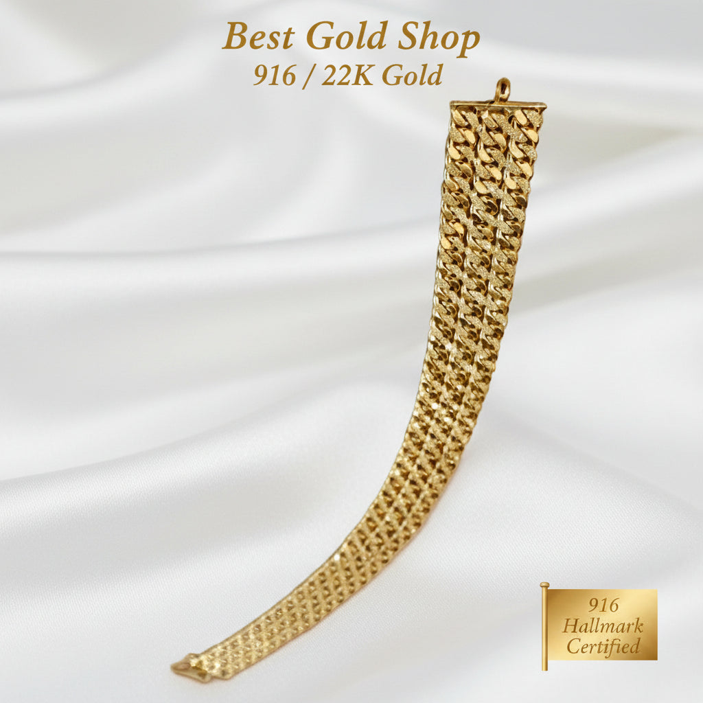 Vertical view of 916 Gold (22K) Triplet Cowboy Chain Bracelet on white satin.