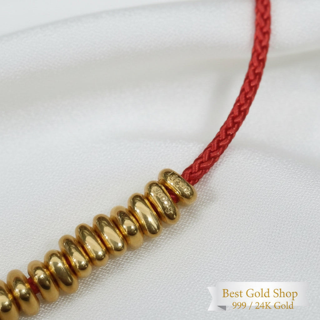 999 gold hallmark detail on bead strand red cord bracelet