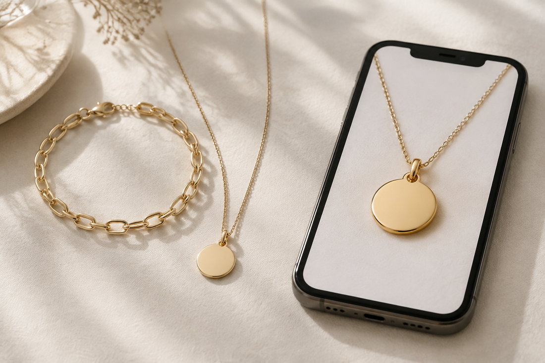 Gold pendant necklace and oval-link bracelet beside a smartphone displaying a close-up of the pendant.