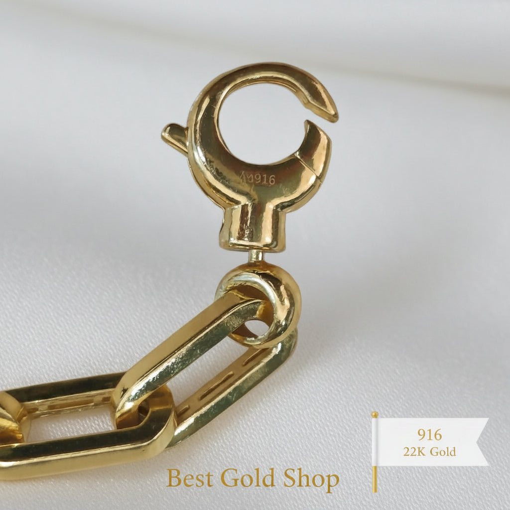 Close-up of 916 gold bracelet dangling heart charm