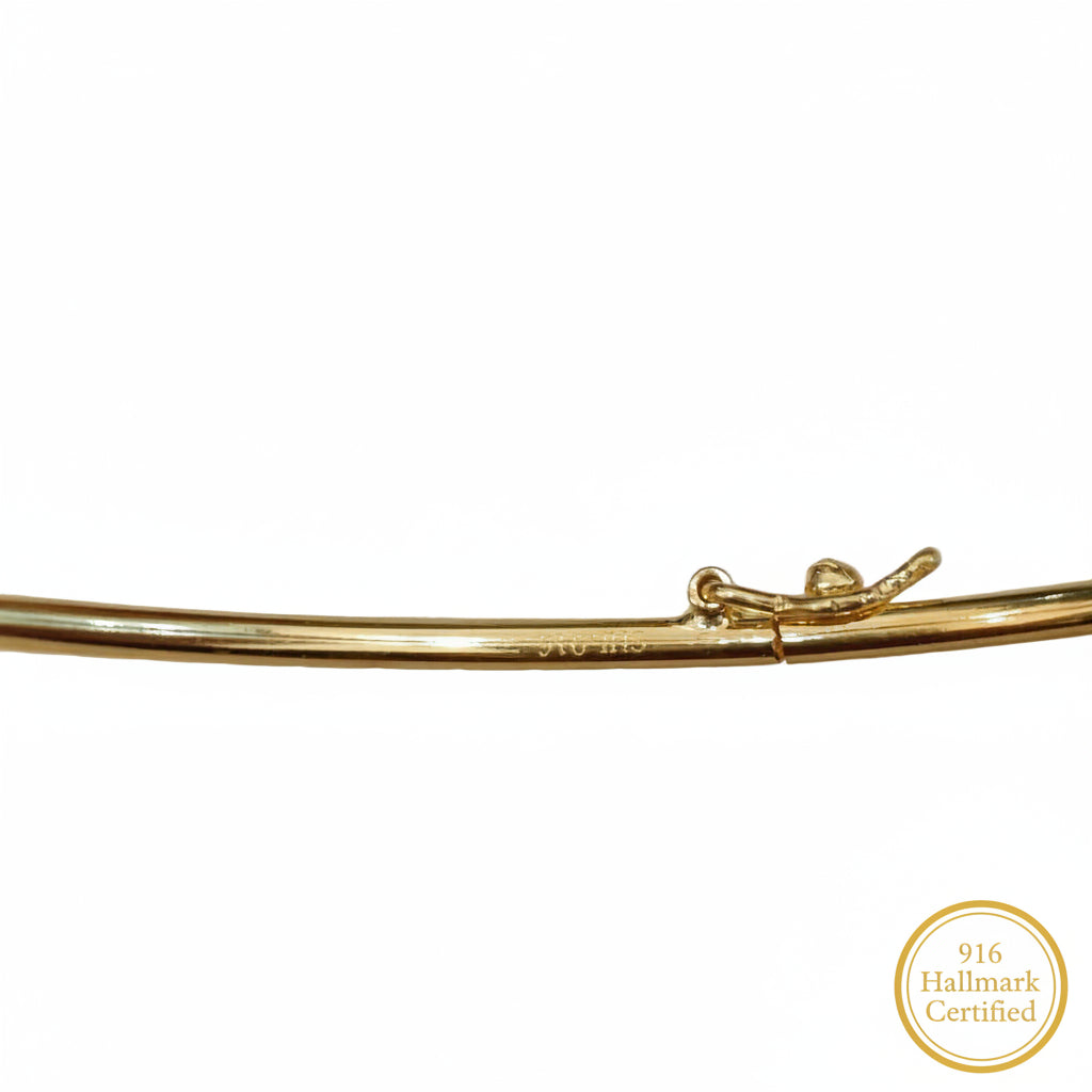 Close-up of the 22K gold slim bangle and diamond-cut finish