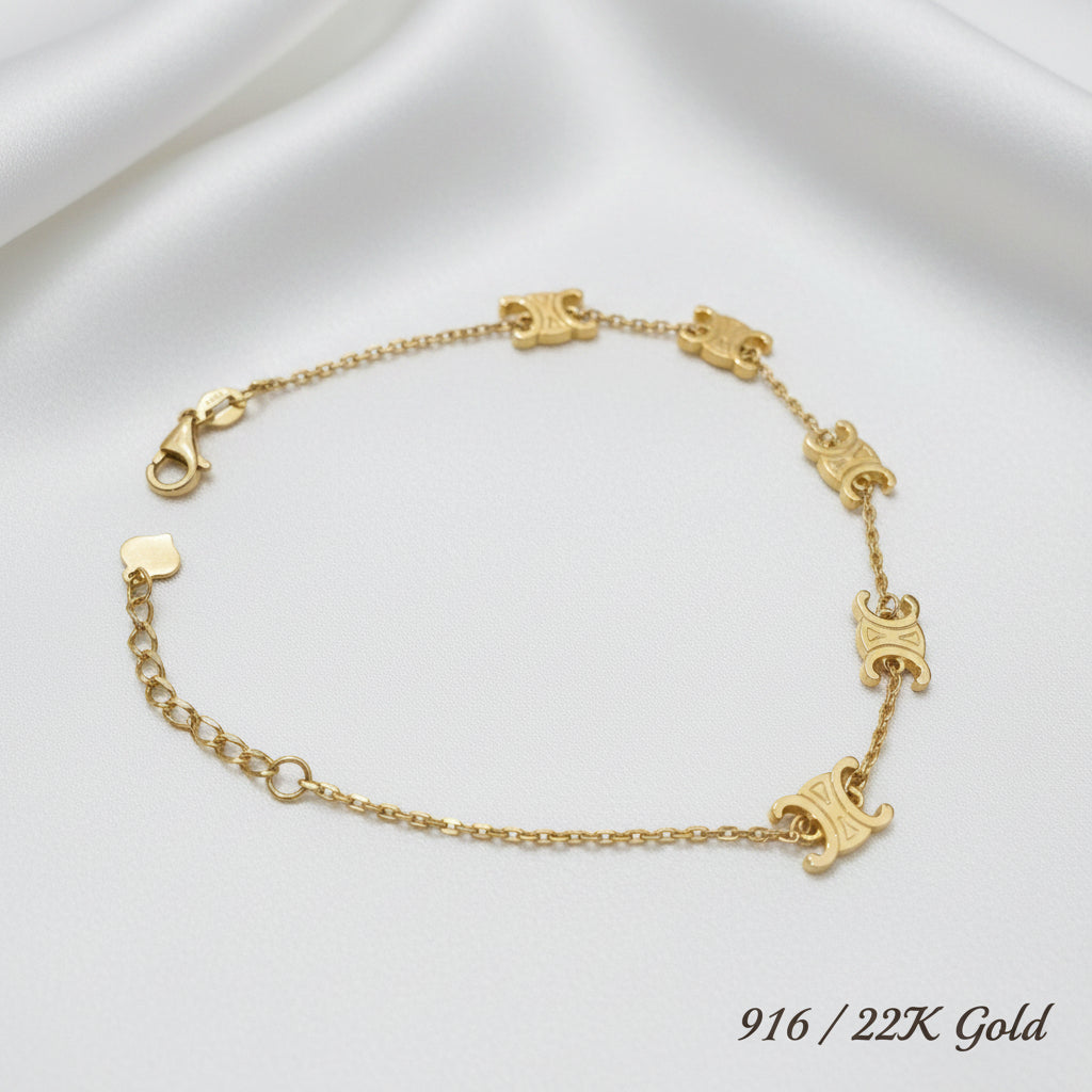 916 gold adjustable fancy motif bracelet on a neutral background