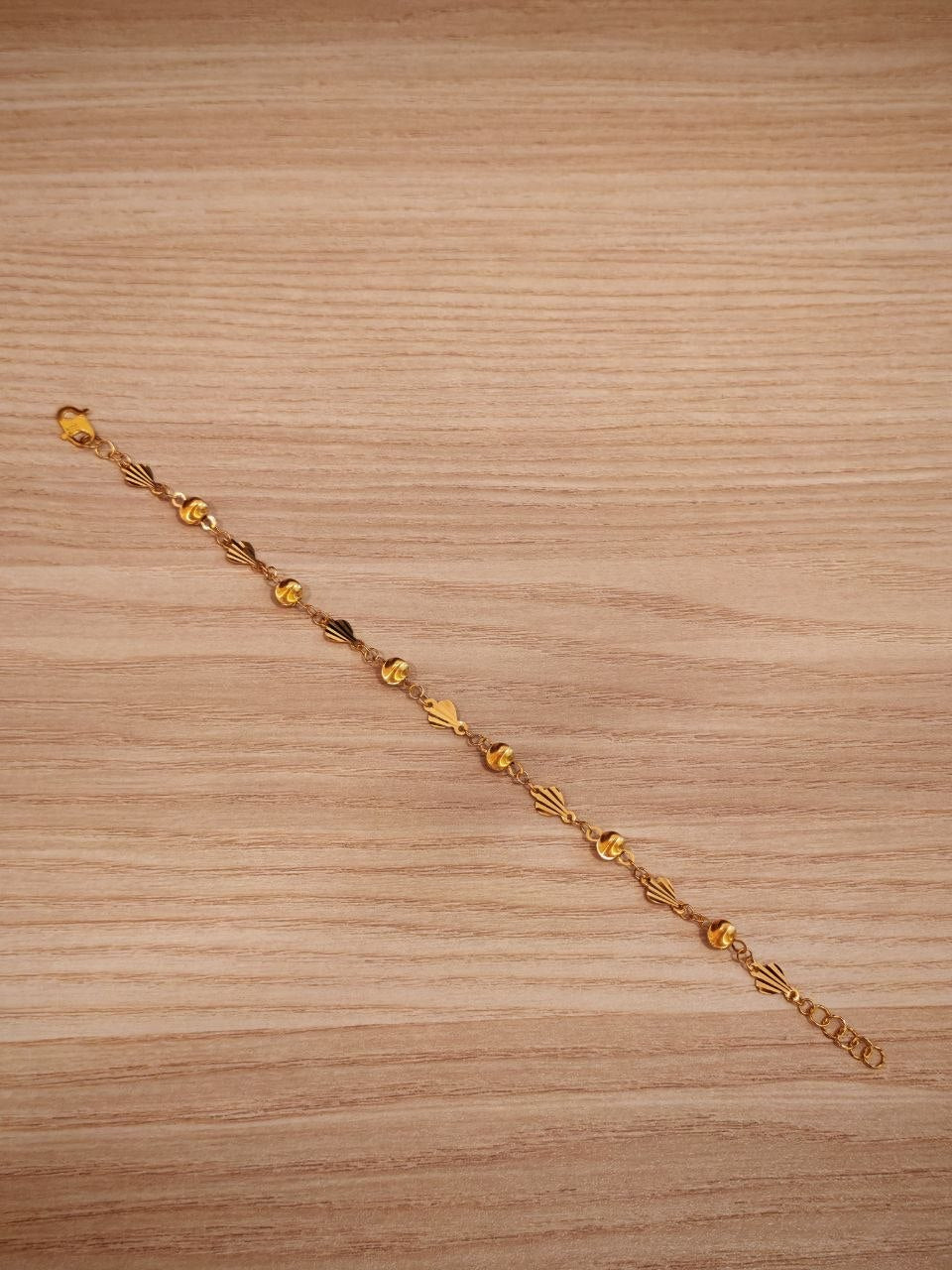 916 gold fancy shell ball bracelet laid flat