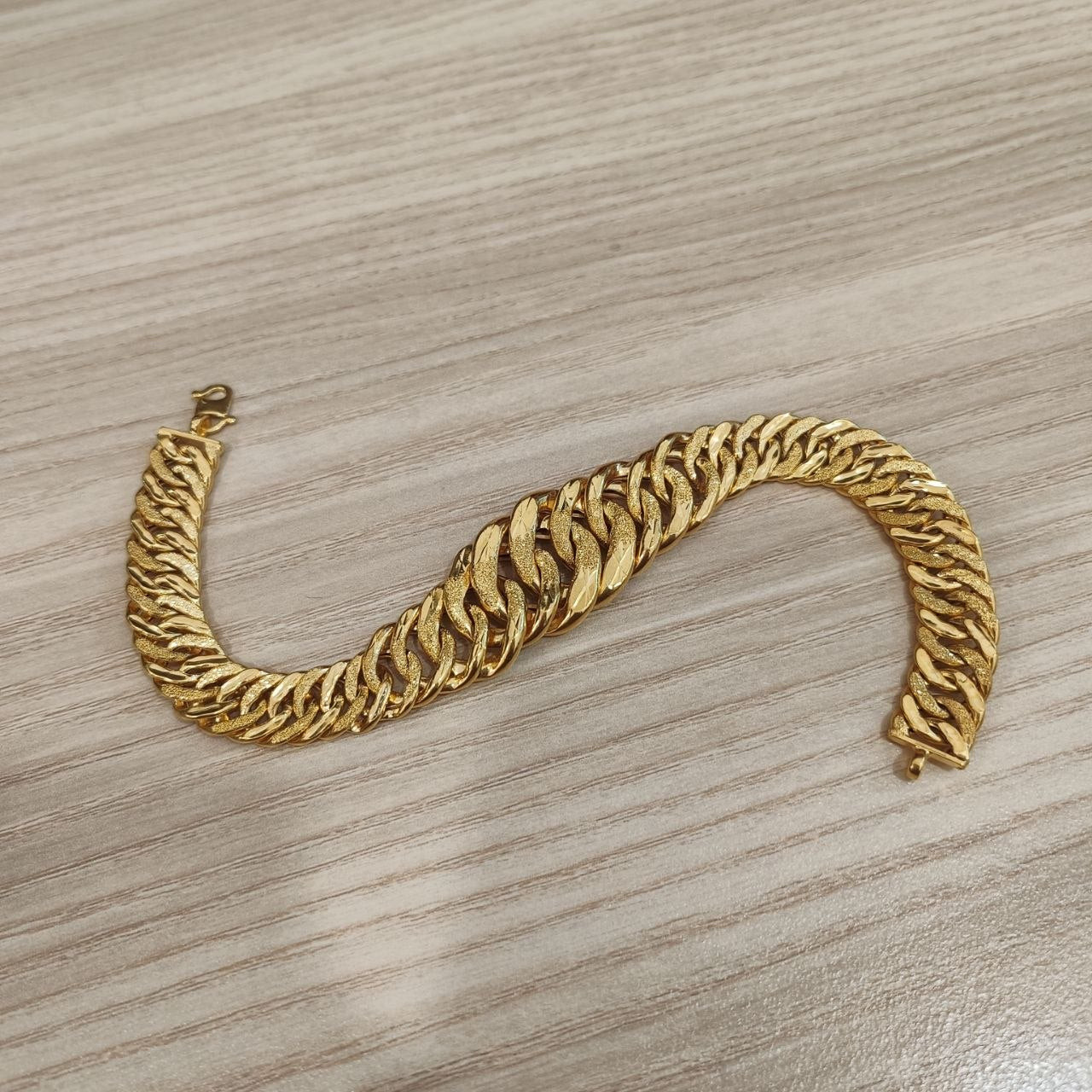 Close-up of the polished and textured links on the 22K gold Lipan bracelet