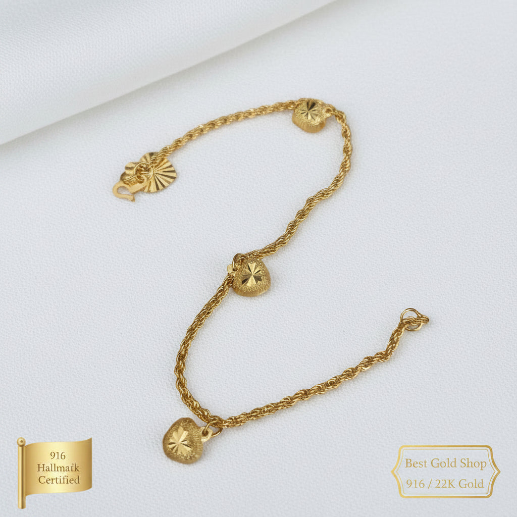916 Gold hollow rope bracelet with dangling heart charms laid flat