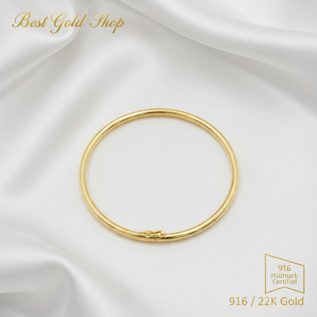 916 gold hollow shiny bangle on a white background