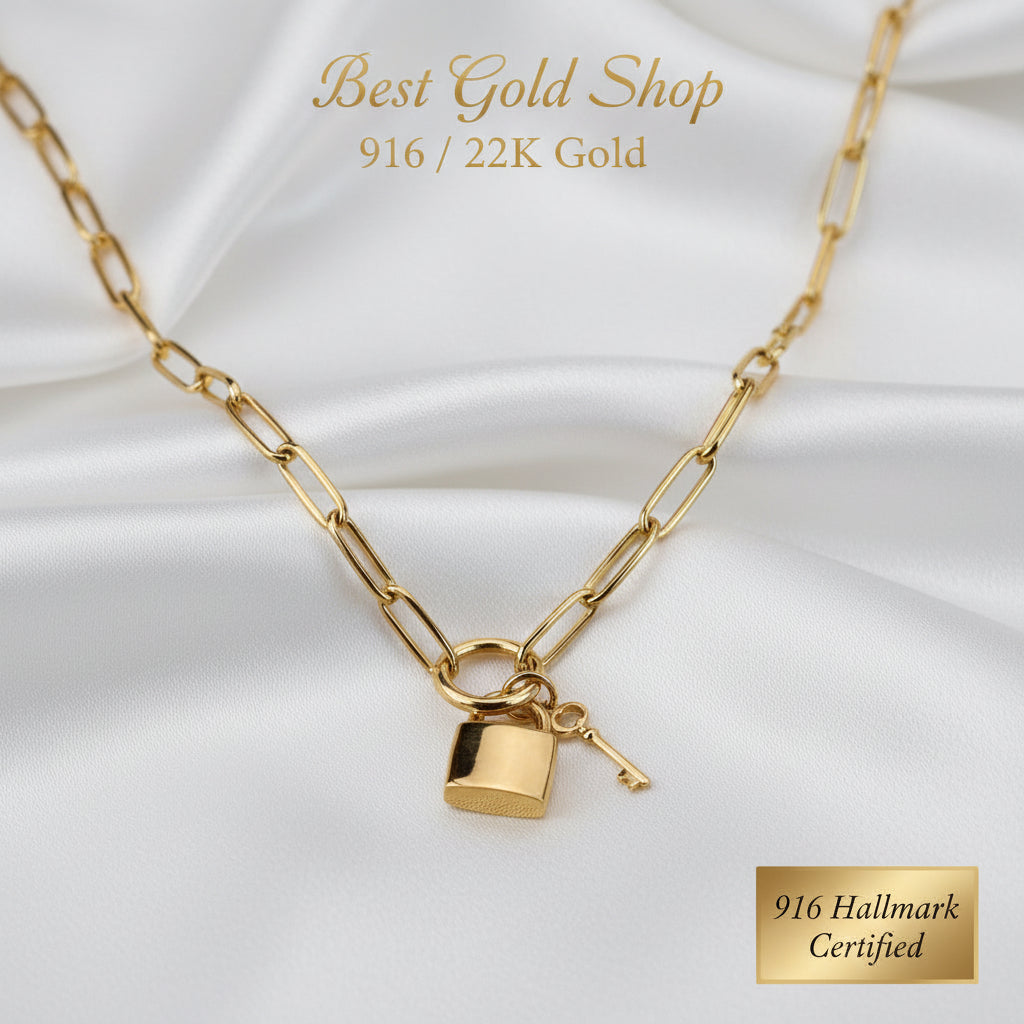 Close-up of the lock and key charms on a 916 Gold Paperclip necklace.