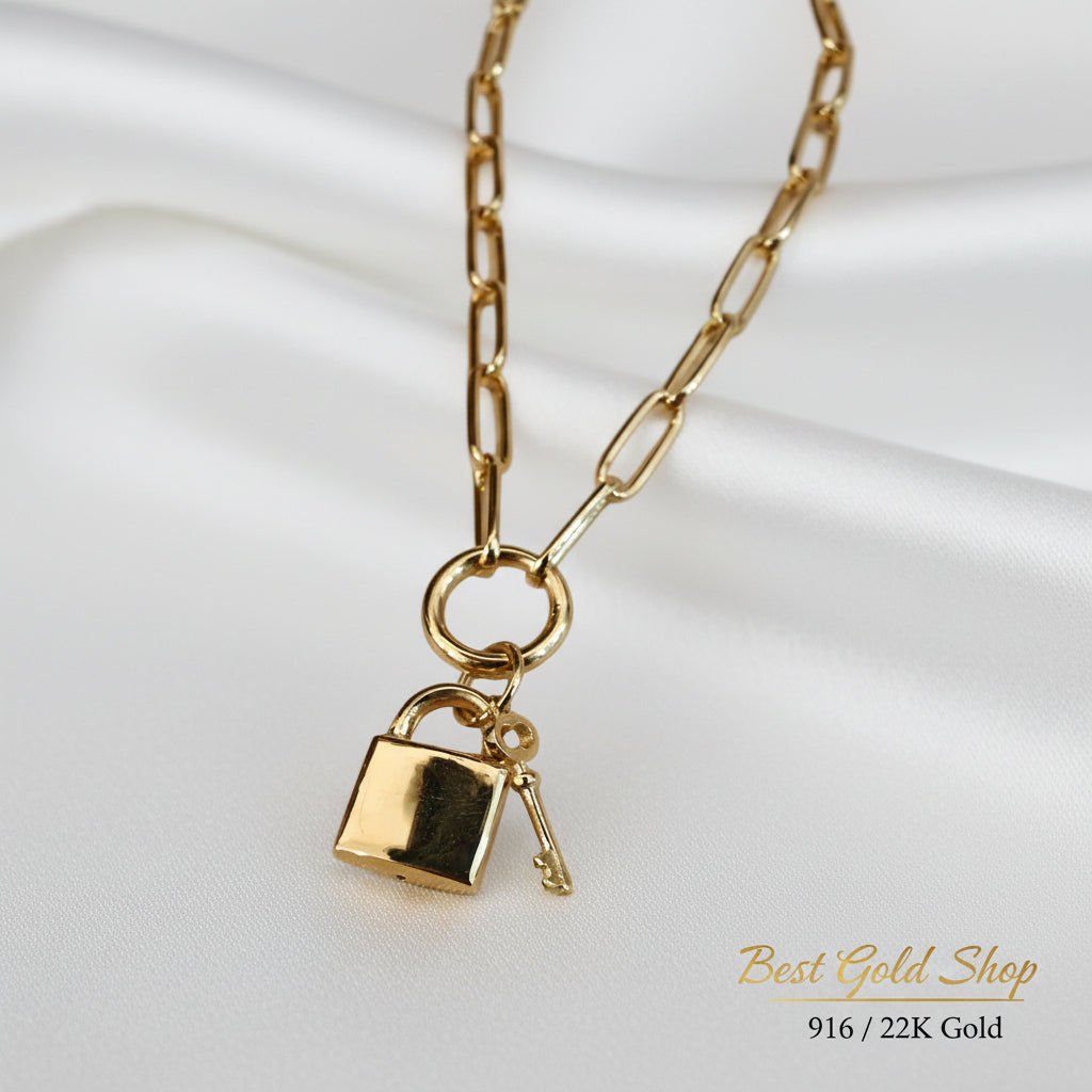 Close-up view of 916 Gold Lock & Key Paperclip necklace charms.
