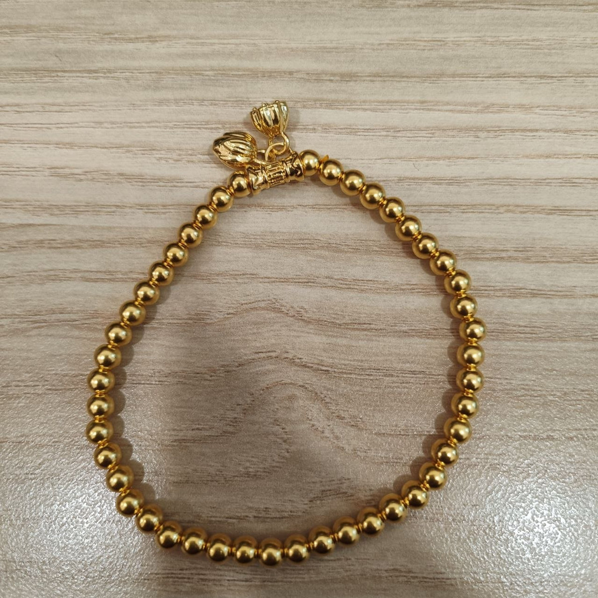 999 gold bead lotus bracelet with dangling lotus charms - front view