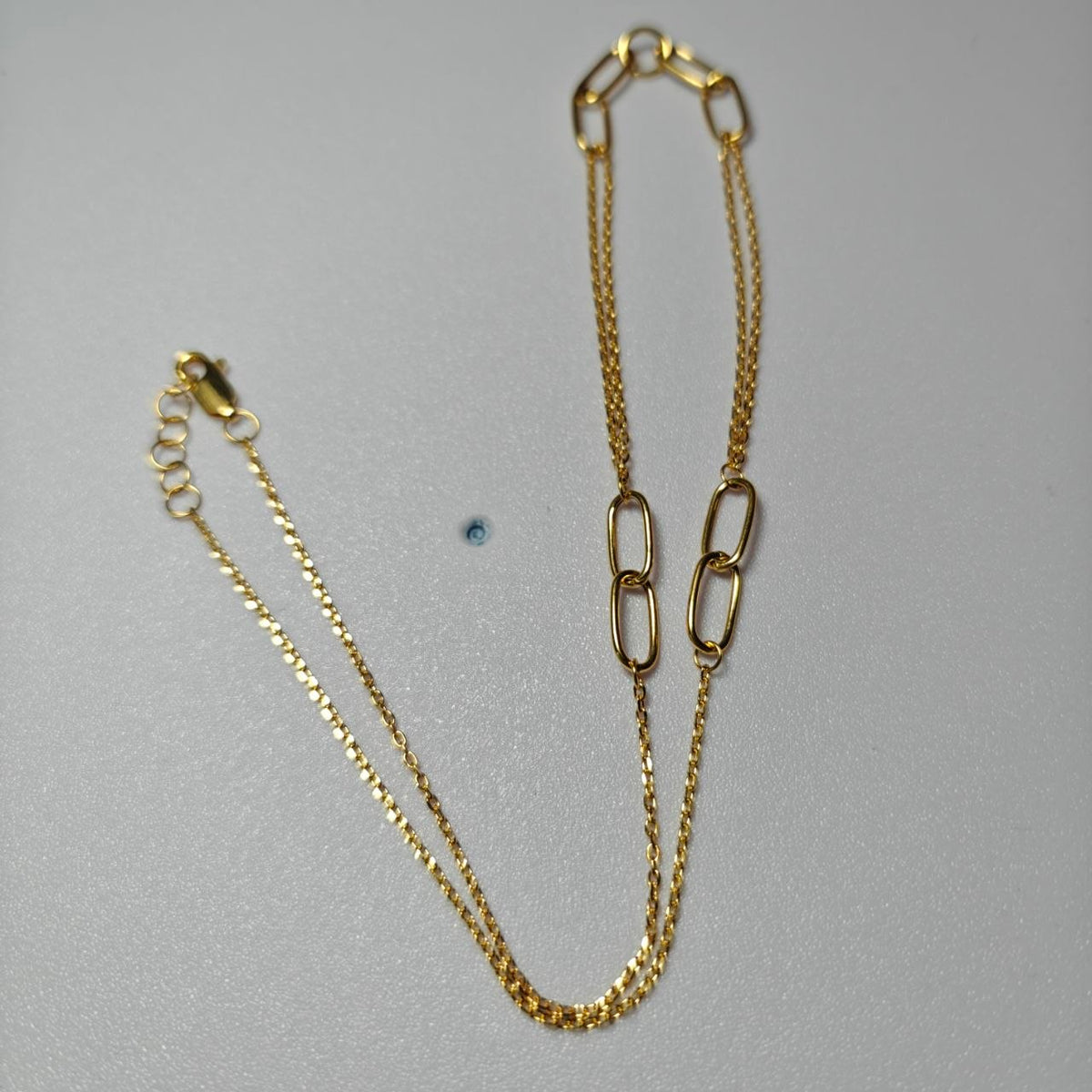 Detail of oval loop and fine chain sections on 916 gold necklace